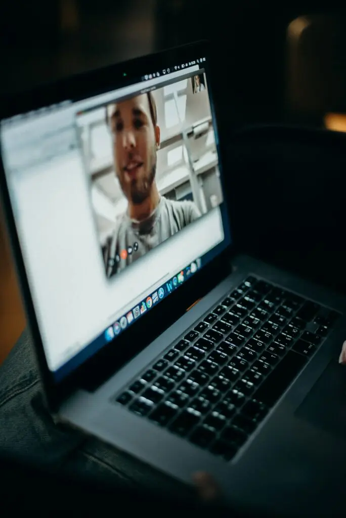 A young man and young woman video chatting on a laptop